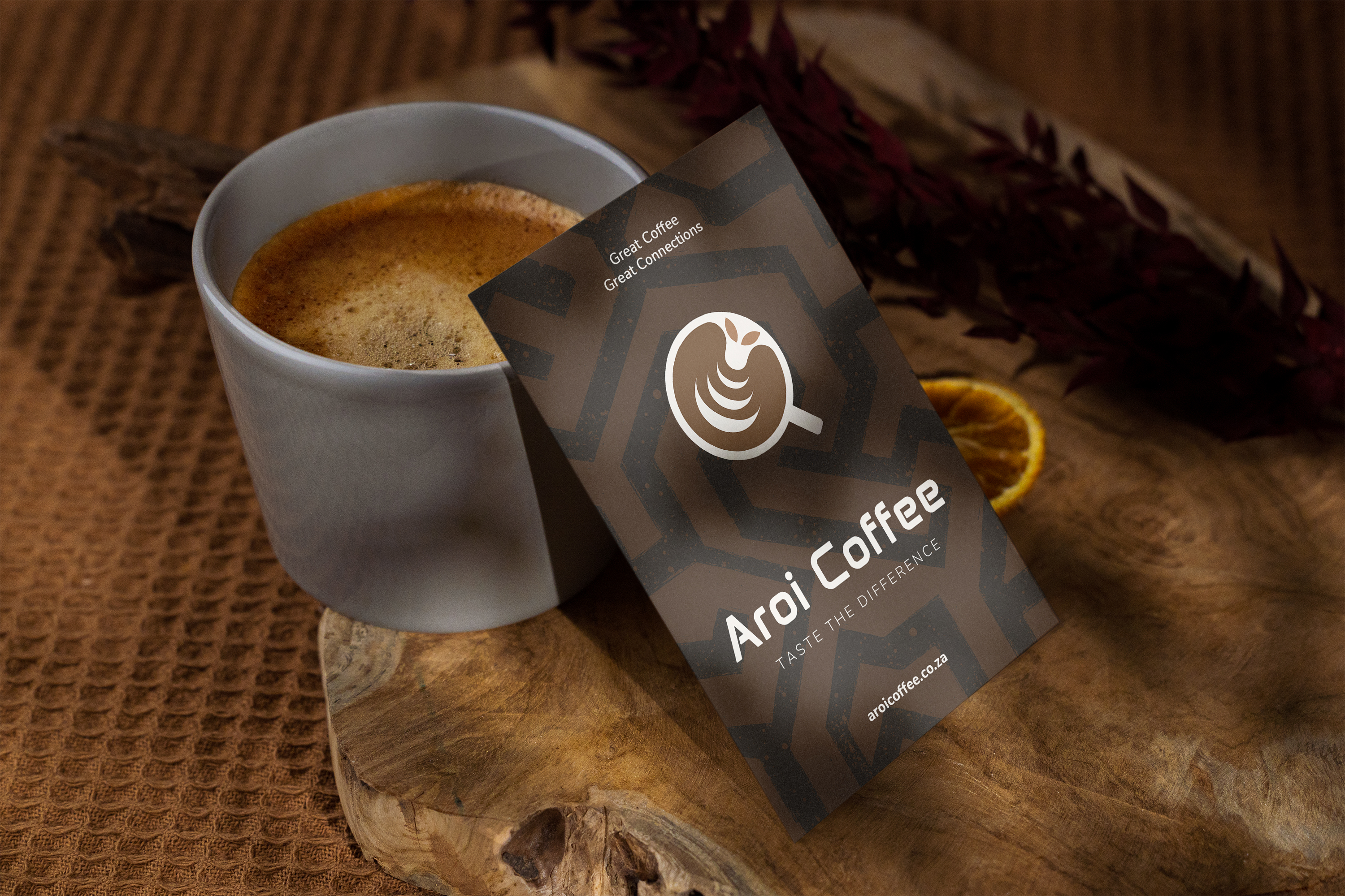 Aroi Coffee branded flyer beside a mug of coffee